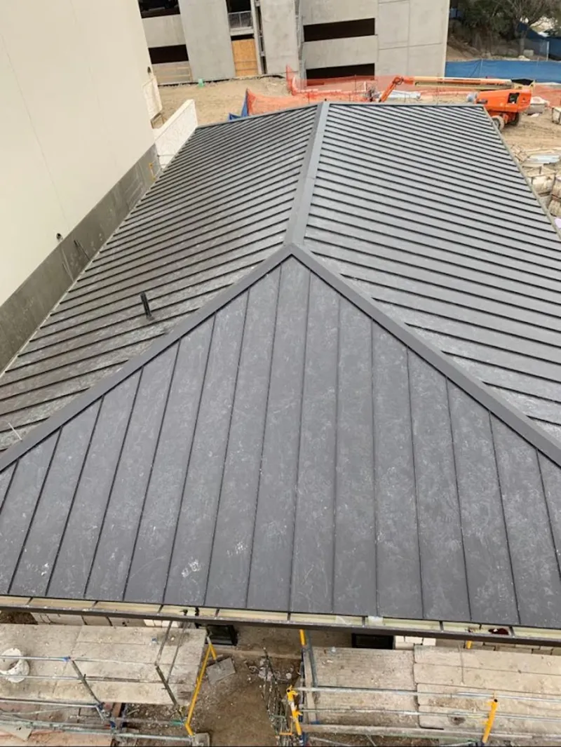 Commercial metal roof construction with crane equipment in Leesburg